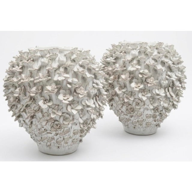 This exquisite pair of white ceramic vases showcases masterful craftsmanship, defined by hundreds of individually applied,...