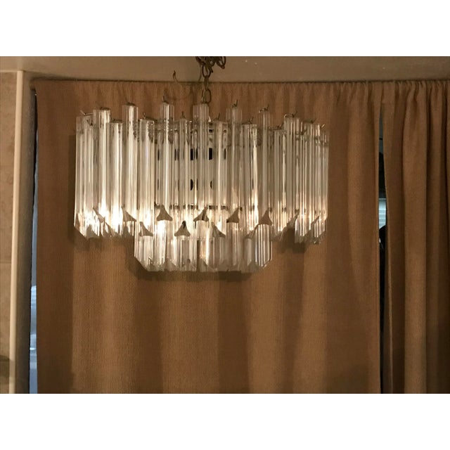 This elegant two tier chandelier from the 1960s shows a chrome hardware base and ten sockets. The vintage condition is...