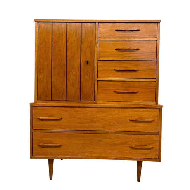 Vintage mid-century modern gentleman's chest featuring a versatile combination of drawers and cabinet storage. The upper...