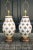 Large spectacular pair of ceramic fleur de lis lamps. White and gold gilt glaze. Wood bases. 26" high to the top of the...