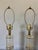 Pair of cylindrical stacked lucite table lamps. Arranged with alternating pieces of frosted and clear lucite with brass...
