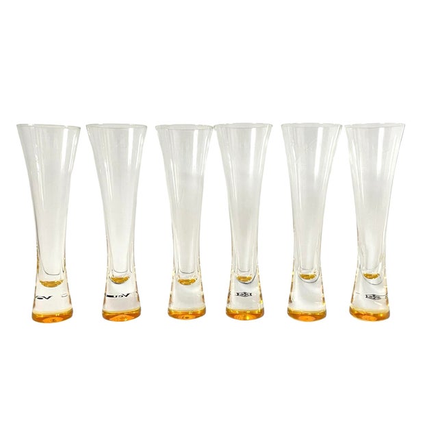 Add a touch of elegance to your champagne celebrations with this set of six Veuve Clicquot glass champagne flutes. Made in...