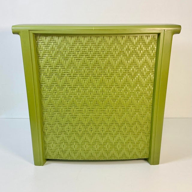 A Mid-Century staple in homes across America. This plastic hamper is from the 1960s featuring a faux wicker design on the...