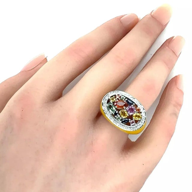 This lovely ring is crafted from 14k white gold with a polished finish and has an oval top set with assorted size and...