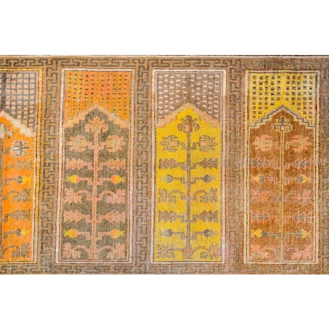 A unique early 20th century Central Asian pictorial Khotan rug with six panels, each depicting a blossoming tree woven in...