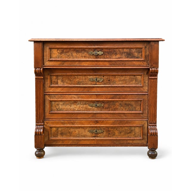 Antique Louis-Philippe style four-drawer chest. Made of wood and veneer with a beautiful decorative burr walnut grain. Its...