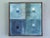 GEOMETRIC COLLAGE IN BLUES Size: 16.9 x 16.9 inches (including frame) Mixed media on wooden panel A very unique original...