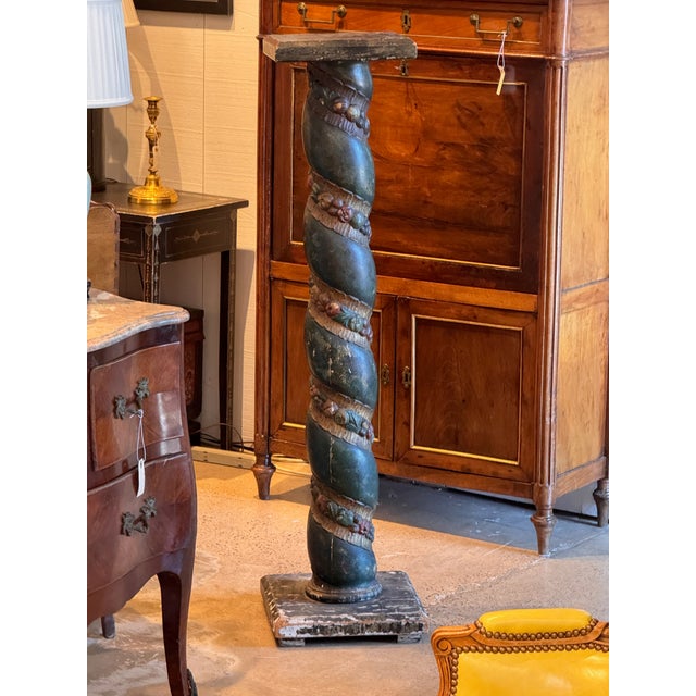 Italian carved and painted column pedestal, the spiral-twist shaft polychromed in deep teal-green and wound with a carved...