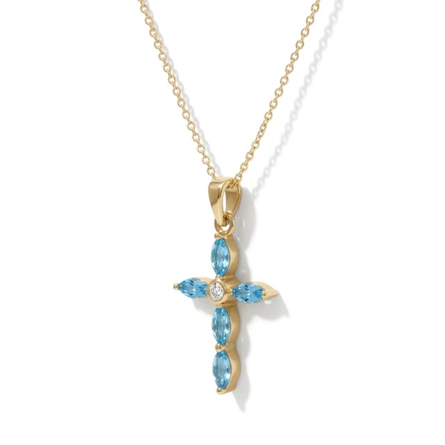 Capture the serene beauty of the heavens with this elegant Marquise Blue Topaz Cross Necklace. This delicate piece...