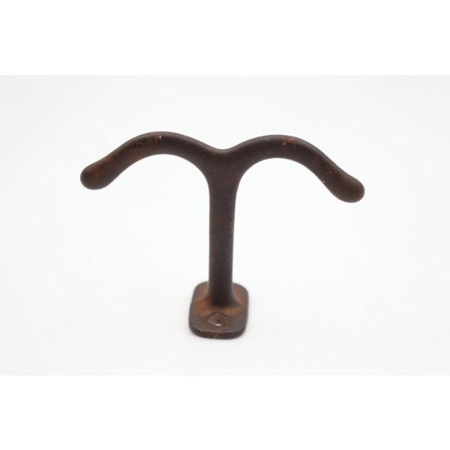 Vintage ceiling mount double arm hook made of cast iron with a black finish. The original mounting screws are not...