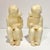 Pair of vintage Italian figurines hand-carved from alabaster stone depicting seated macaques holding apples. Each...