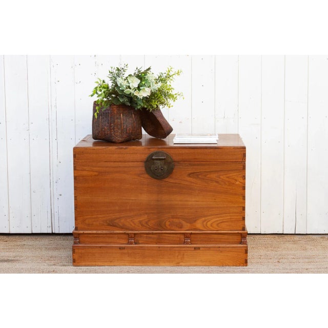 A handsome antique campaign style camphor wood chest, this oversize Chinese trunk is a testament to timeless...