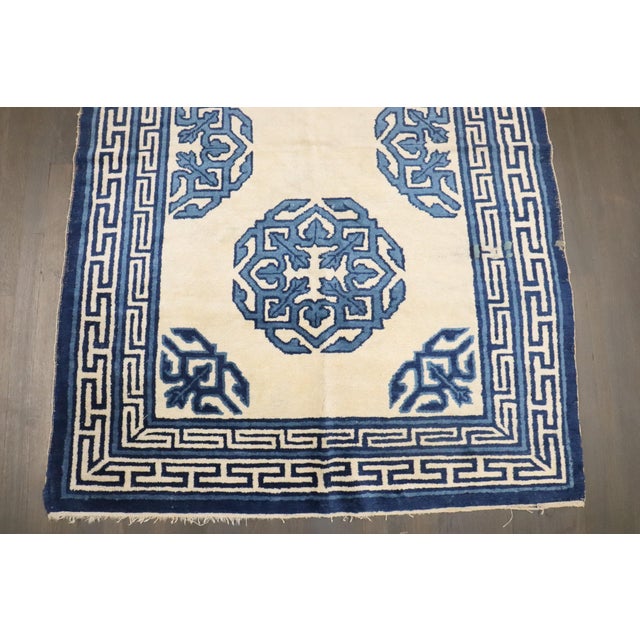 a 19th-century ivory and Blue Chinese Peking Carpet Details rug no. 10823 size 4' x 5' 9" (122 x 175 cm)
