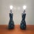 Pair of Italian dark colored ceramic pottery lamps featuring eggshell blue accents throughout the body. These lamps have a...