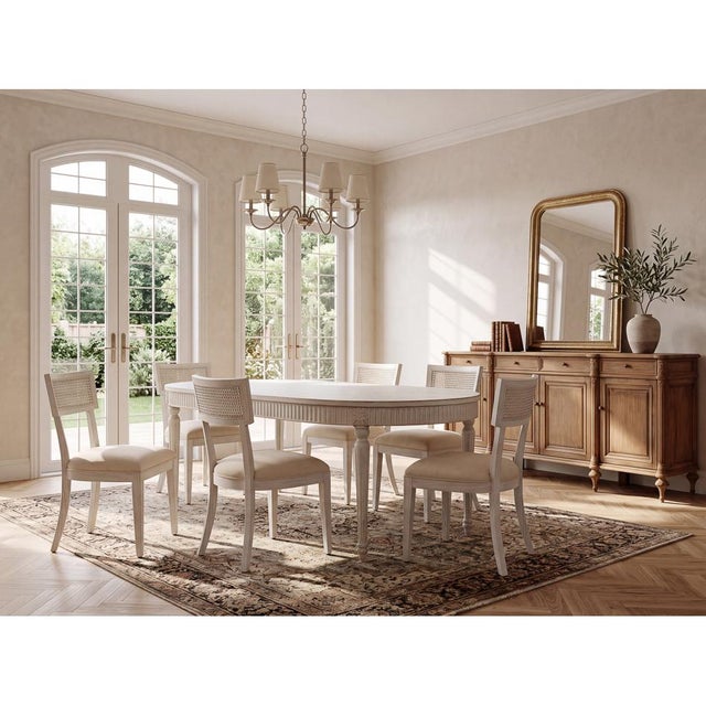 Old pine boards form the plank top and carved apron, with a worn white finish that reads as softly sun-bleached rather...