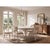 Old pine boards form the plank top and carved apron, with a worn white finish that reads as softly sun-bleached rather...