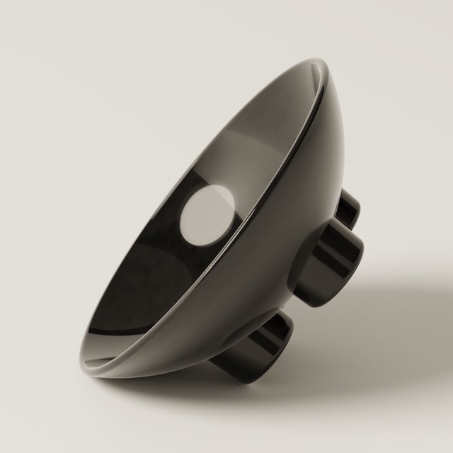 A sculptural ceramic bowl with a super glossy finish, ideal for fruit, dried flowers, or as a standalone art object. Part...