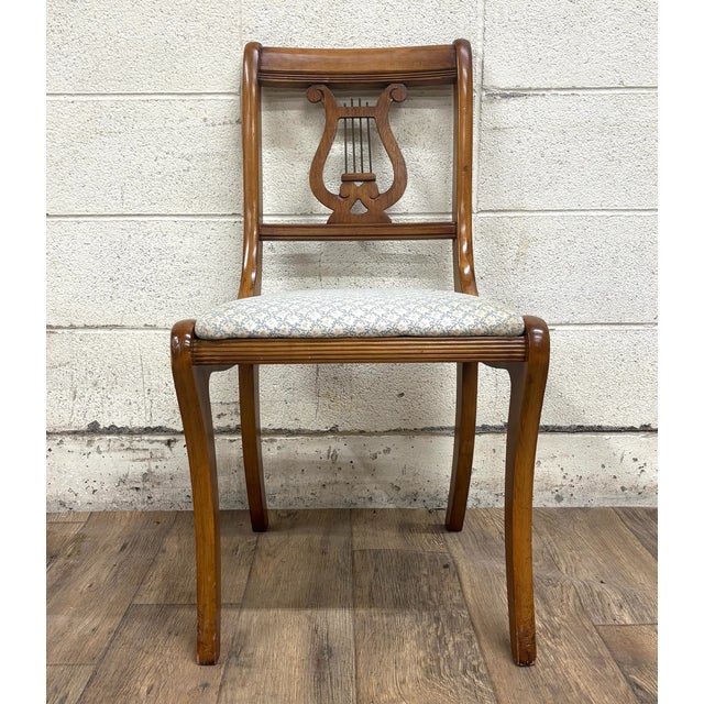 This is a stunning vintage Regency Duncan Phyfe style harp back or lyre back upholstered dining chair. Appears to be...