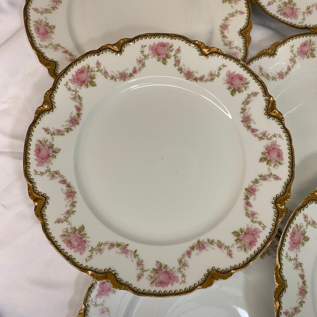 Offered here is a set of 8 French Limoges dinner plates. They feature delicate pink roses and gold encrusted rims. These...