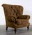 This Sherrill lounge chair has a dramatic curved barrel back with deep diamond tufting, generous scroll arms, and turned...