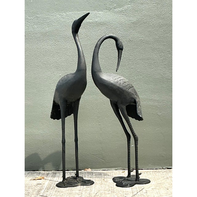 This exquisite pair of vintage cast aluminum standing cranes captures the graceful essence of the Hollywood Regency and...