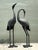 This exquisite pair of vintage cast aluminum standing cranes captures the graceful essence of the Hollywood Regency and...