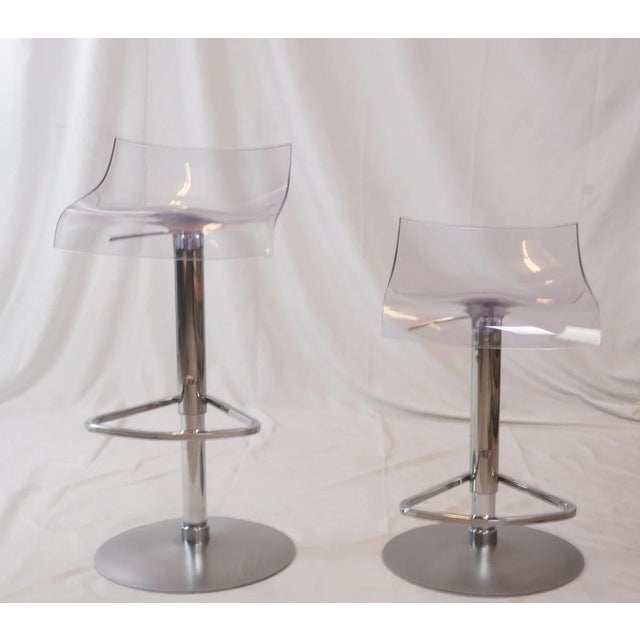 The PAM Adjustable Stools by Studio Archirivolto embody sleek, contemporary design with a light, modern presence....