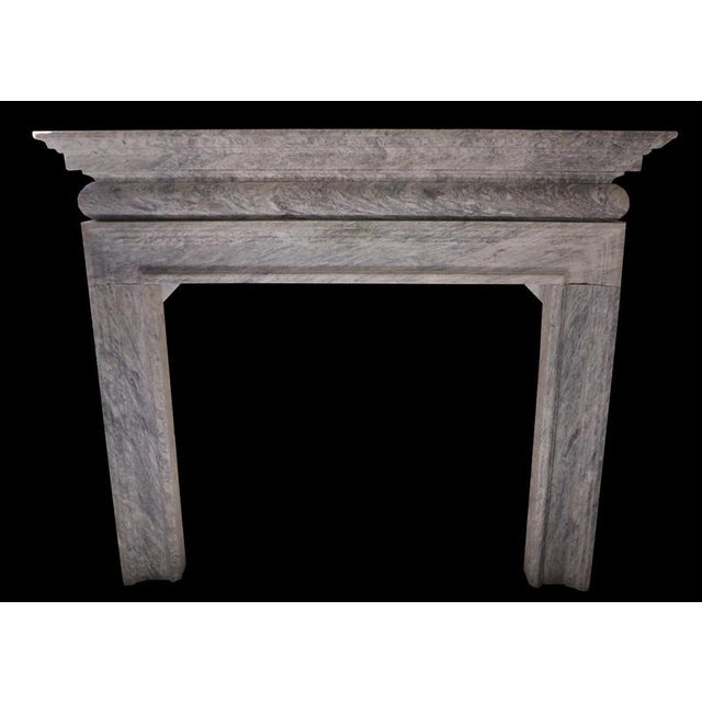 This elegant 20th-century French fireplace is crafted from richly veined marble in a soft palette of blue-grey and dove...