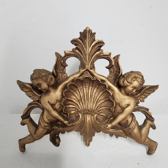 This rare three-piece carved wood canopy crown set includes a dramatic central shell and cherub pediment and two winged...