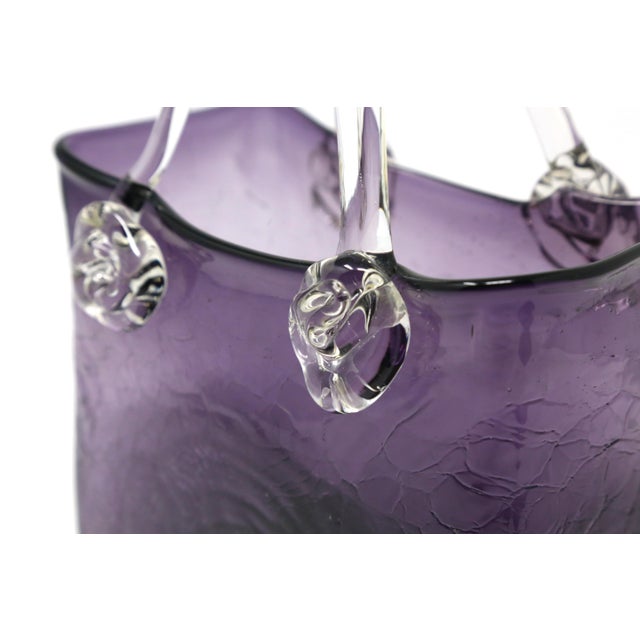 A vintage, amethyst-colored art glass handbag or purse, with a crackle finish and clear handles. Good condition.