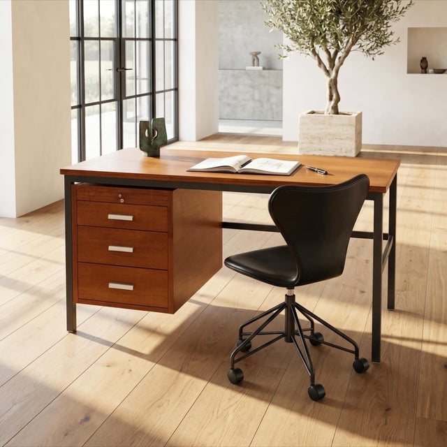 Freestanding desk executed in teak by a danish cabinetmaker. the desk combines a teak cabinet with a black lacquered steel...