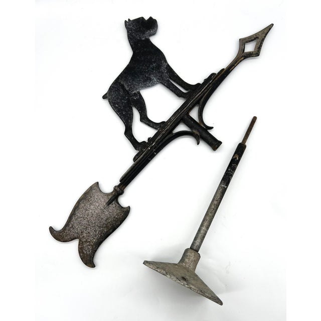 A striking early 20th century cast-iron weathervane featuring a proud Boxer dog silhouette atop a directional arrow and...