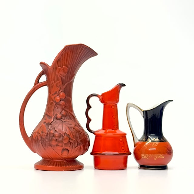 Burnt orange textured pitchers, group of 3. Gorgeous set of unusual assorted burnt orange, black, and gold ceramic...