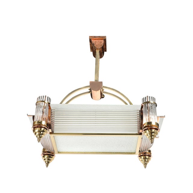 This striking Art Deco Machine Age rectangular pendant chandelier, crafted in France circa 1935 by René Pottier, is a...