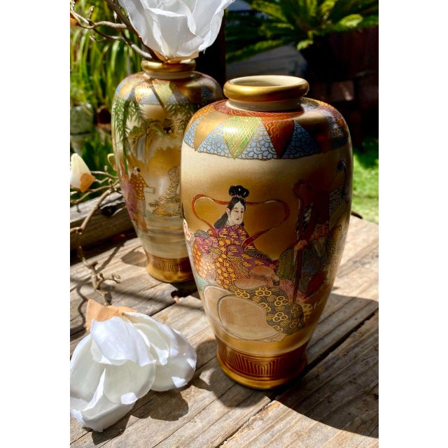 A beautiful matched pair of antique Japanese Satsuma vases depicting the Seven Lucky Gods (Shichifukujin), beloved figures...