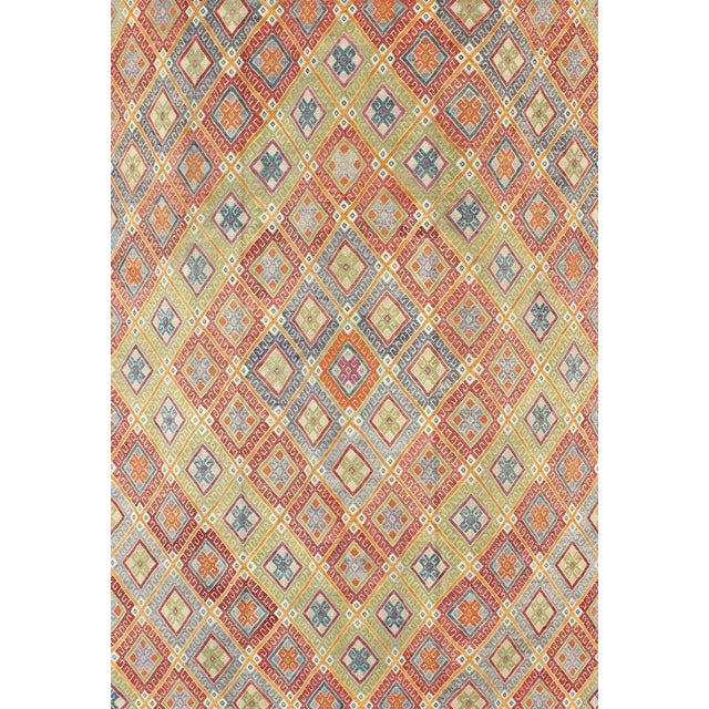 This geometric Kilim from Turkey bears a repeating large diamond design consisting of patterns of smaller, intricate,...