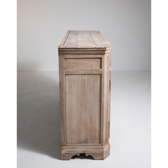 A substantial oak buffet featuring traditional French craftsmanship and generous storage capacity. The simple yet strong...