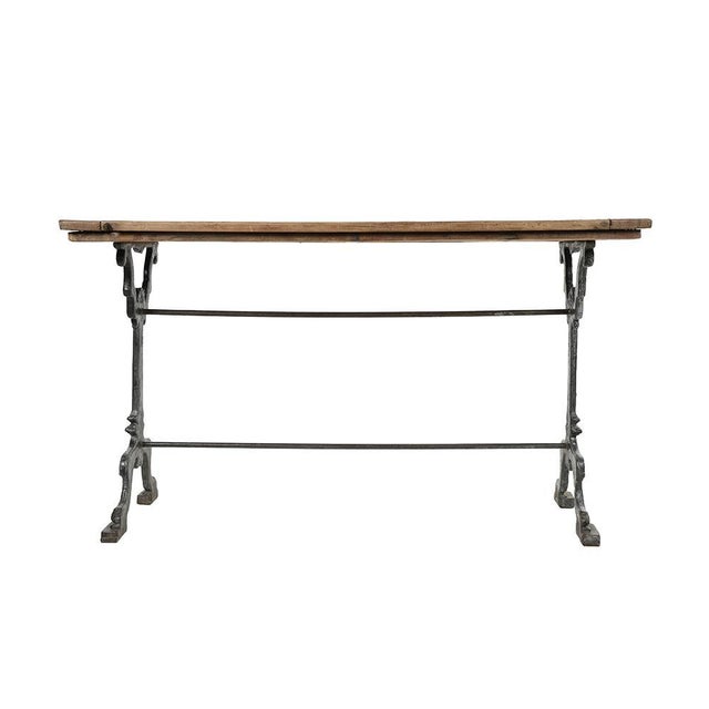Cast iron and patinated wood bistro table. This piece is designed in the style of the selected designer and/or manufacturer