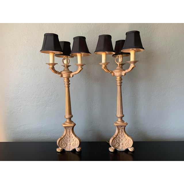 Pair of HIgh End French style Bouillette Lamps with gold metal bases and black shades. Carved bases with flutes and lion's...