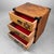 This jewelry chest from the 1980s is made from beautifully grained wood and finished with metal corner fittings and...