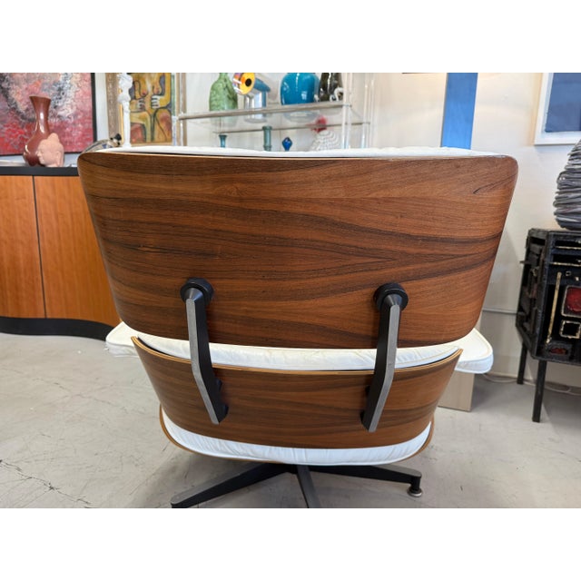 We acquired a pair of early 1980’s vintage Herman miller Eames Chairs in rosewood veneer and white leather. We sold one...