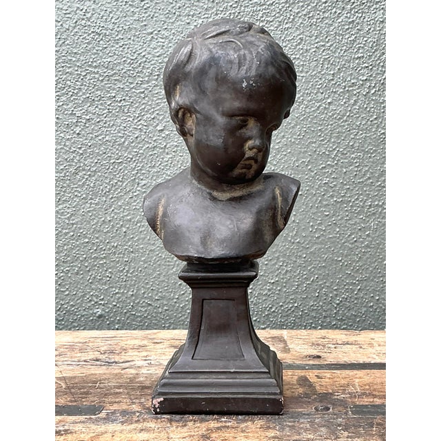 This charming vintage cast bronze bust captures the timeless innocence and softness of childhood through classical...