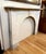 This early 20th century white arched Carrara marble mantel is part of a series of mantels acquired from a New York City...