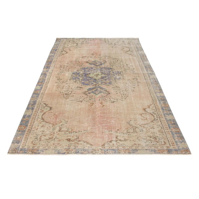 Decorative washed out handknotted vintage rug from Oushak region of Turkey. Approximately 50-60 years old. In very good...