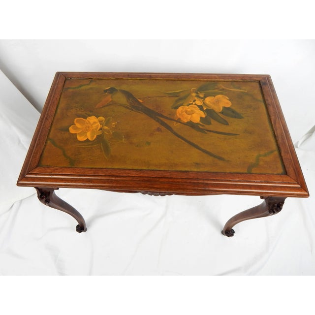 Charming vintage French Style carved wood table with a decoupaged top featuring a lovely scene of a bird perched amidst...