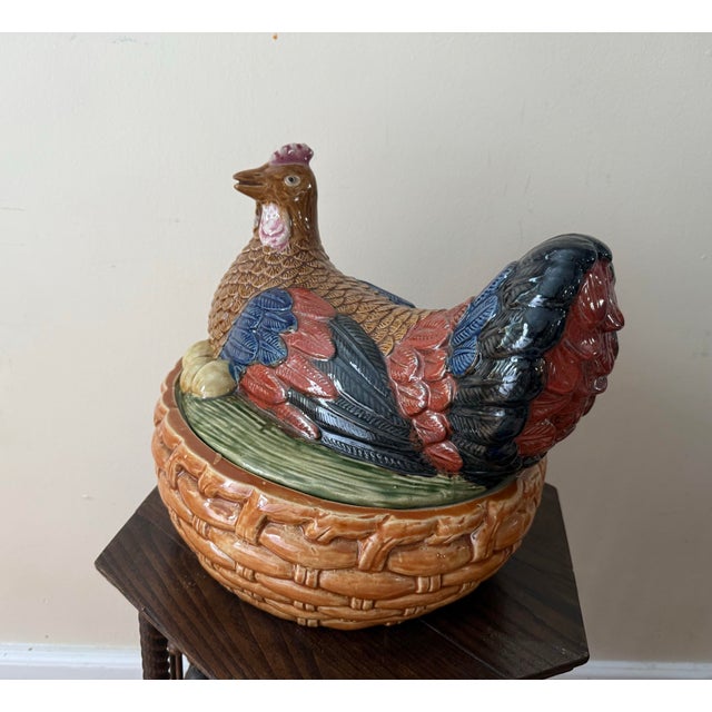A striking large-scale majolica hen on nest tureen, hand-painted in rich ochre, cobalt blue, brick red, and black glazes...