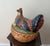A striking large-scale majolica hen on nest tureen, hand-painted in rich ochre, cobalt blue, brick red, and black glazes...