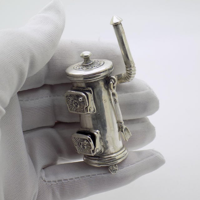 A charming vintage miniature depicting a traditional wooden stove, handmade in Arezzo, Tuscany, Italy between the 1970s...