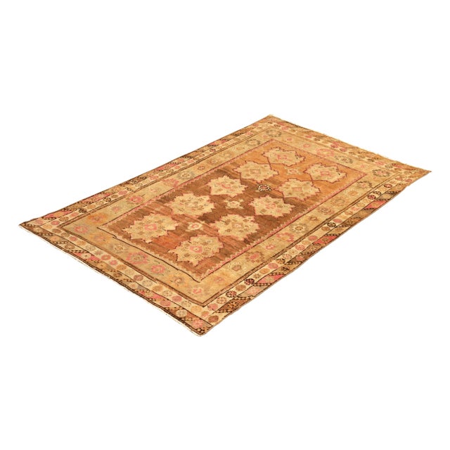 Hand knotted in wool from a notable sheen yarn originating from Turkey circa 1950-1960, this mid-century rug remarks a...