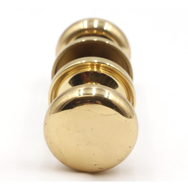 Vintage Classic style polished brass door knob set with matching rosettes. Good condition with surface wear. The rosette...